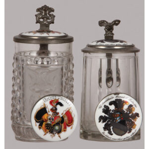 Glass steins (two), porcelain inlaid lids.